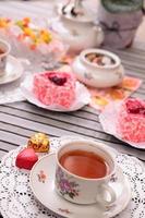 Warm cup of tea and sweets photo