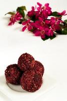 Spring sweets: chocolate truffles with flowers photo