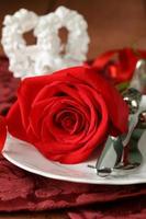 romantic table setting with roses for the holiday St. Valentine photo