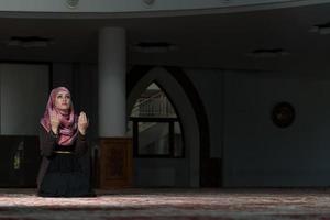 Muslim Woman Praying In Mosque photo
