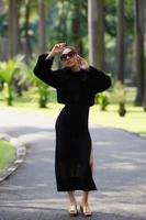 Beautiful Asian lady in black dress, posing at the park photo