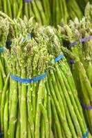 bunch of fresh asparagus from market shelves real