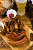 Grilled sausages with roast potato with spices photo