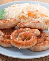 Bavarian fried sausages on sauerkraut photo