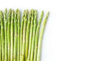 Green asparagus at the left of white background