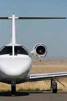 White private jet on the runway photo