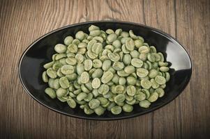 Cup with green coffee beans