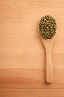 Mung beans with wooden spoon photo