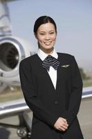 flight attendant in front of private jet photo
