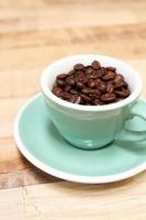 Coffee beans in green cup photo