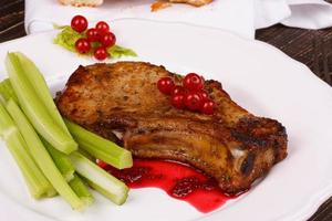 Fried pork chop with red currant sauce and celery