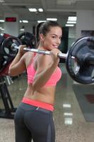 fitness woman lifting weight in gym photo