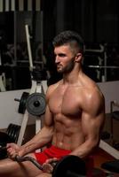 Man Lifting Barbell In Gym photo