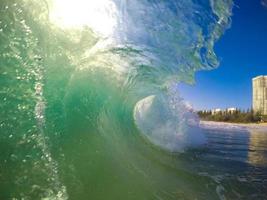 Green Glassy Wave breaking on the beach photo