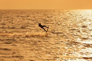 Kite surfer jumping from the water photo