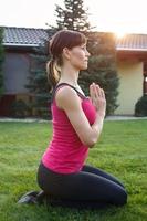 Young sporty brunette woman posing yoga