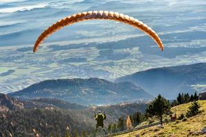Paraglider is flying in the valley photo
