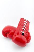 Red boxing gloves on white background