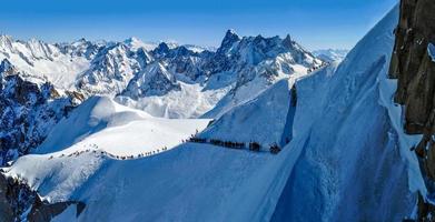 Panorama with skiers heading for Vallee Blanche, France