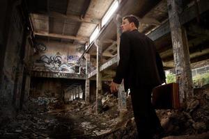 Confused Business man inside a Destroyed Building