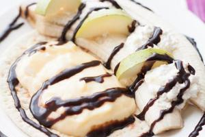 curd dessert with banana, pear and chocolate sauce