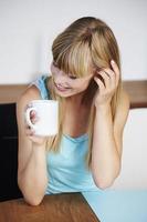 Woman smiling over coffee photo