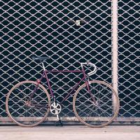 Road bicycle and concrete wall, urban scene vintage style