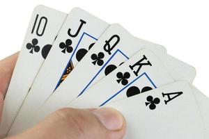 royal flush playing cards in hand. photo