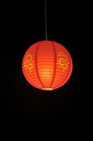 Hanging Chinese Lantern against a black background photo