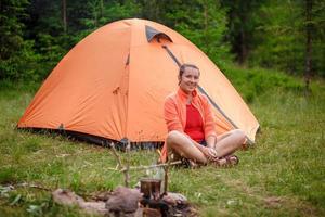 cheerful woman tourist tent photo