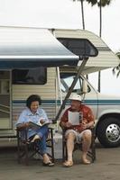 Couple Relaxing Outside Their RV photo