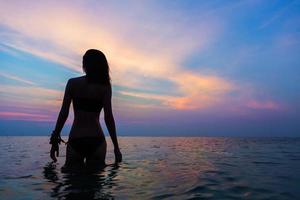 beautiful female silhouette in the evening sea