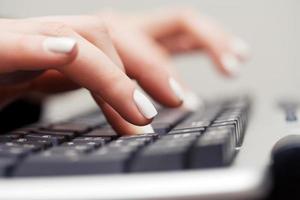 Female hands typing on comuter keyboard photo
