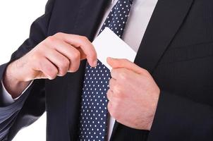 Businessman putting blank card in his pocket.