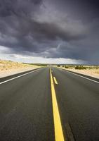 Desert road and storm photo