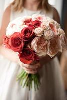 Flower girl holding bridal bouquet