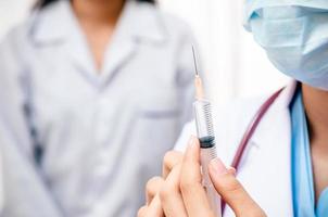 doctor holding syringe