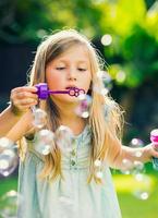 little girl with soap bubbles photo