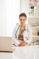 portrait of medical doctor woman in office photo