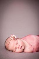 Peaceful Newborn Baby Girl Swaddled in Blanket, With Copy Space photo