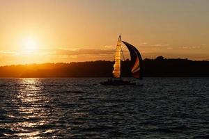 Sail ship at the sunset. photo