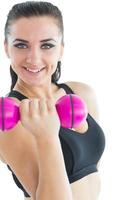 Active woman making use of dumbbells photo