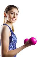 Fit woman lifting pink dumbbell photo