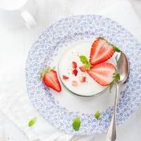 Strawberry tiramisu, trifle, custard dessert with mint leaves photo