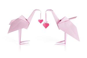 Origami pink paper flamingo couple