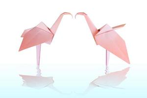 Origami pink paper flamingo couple