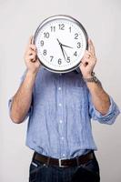 Man holding clock, show time to you. photo