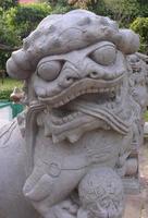 chinese lion statue in Wat Arun photo