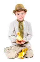 Boy with cute ducklings photo