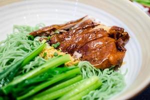 roast duck with green noodle soup photo